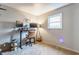 Functional office space featuring a sit-stand desk, dual monitors, and neutral carpeted floors at 48 Wilson Dr, Carmel, IN 46032