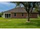 Brick home featuring a glass enclosed sunroom and a well-manicured lawn at 5032 Monticello Dr, Columbus, IN 47203