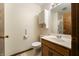 Bathroom featuring a white vanity with wood trim, white toilet, and shower with glass door at 5032 Monticello Dr, Columbus, IN 47203