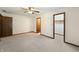Bedroom featuring a ceiling fan, neutral carpet, and an open closet at 5032 Monticello Dr, Columbus, IN 47203