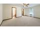 Spacious bedroom with neutral carpet, ceiling fan, and en suite bathroom at 5032 Monticello Dr, Columbus, IN 47203