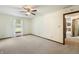 Bedroom features neutral carpet, a window, and an entrance into another room at 5032 Monticello Dr, Columbus, IN 47203