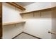 Walk-in closet featuring neutral carpet and built-in shelving and racks at 5032 Monticello Dr, Columbus, IN 47203