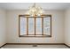 Dining room featuring neutral carpet, a large bay window, and a chandelier at 5032 Monticello Dr, Columbus, IN 47203