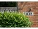 Close-up of the house number '5032' displayed on a brick wall next to a green bush at 5032 Monticello Dr, Columbus, IN 47203