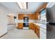 Functional kitchen with white appliances, light countertops, and wooden cabinets at 5032 Monticello Dr, Columbus, IN 47203