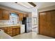 Charming kitchen features oak cabinets, stainless steel refrigerator, and neutral countertops at 5032 Monticello Dr, Columbus, IN 47203