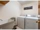 Functional laundry room with a utility sink, washer, and dryer hookups at 5032 Monticello Dr, Columbus, IN 47203