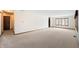 Spacious living room with neutral carpet and a large window for ample natural light at 5032 Monticello Dr, Columbus, IN 47203