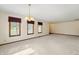 Well-lit living room featuring neutral carpeting, bright white walls, and natural light at 5032 Monticello Dr, Columbus, IN 47203
