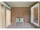 Enclosed patio features brick wall, neutral carpet, and bench with patterned throw pillows at 5032 Monticello Dr, Columbus, IN 47203