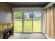 The sunroom includes an electric fireplace and sliding doors with a view of the backyard at 5032 Monticello Dr, Columbus, IN 47203