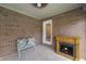 Inviting sunroom with brick walls, a fireplace, and comfortable seating at 5032 Monticello Dr, Columbus, IN 47203