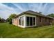 Sunroom on a brick home with large windows and a well-manicured lawn at 5032 Monticello Dr, Columbus, IN 47203