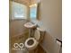 Bathroom featuring toilet, sink, vanity, and window at 535 S 450 E, Franklin, IN 46131