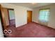 Bedroom featuring plush carpeting, closet, and natural light at 535 S 450 E, Franklin, IN 46131