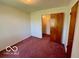 A carpeted bedroom with neutral walls and two doorways at 535 S 450 E, Franklin, IN 46131