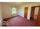 A cozy bedroom with a window letting in natural light and an adjoining door at 535 S 450 E, Franklin, IN 46131