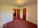 View of bedroom with neutral paint, carpet, and two doorways at 535 S 450 E, Franklin, IN 46131