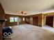 Bright living room with wood paneling, ceiling fan, and a view of the yard at 535 S 450 E, Franklin, IN 46131