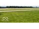 Green lawn leading to a road with fields and trees in the distance at 535 S 450 E, Franklin, IN 46131