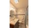 Well-lit bathroom features a vanity with a white sink, toilet, shower, and tiled walls at 5609 Meadowood Dr, Indianapolis, IN 46224