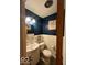 Cozy bathroom features blue walls, white subway tile, vanity and decorative floral art at 5609 Meadowood Dr, Indianapolis, IN 46224