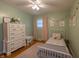 Adorable bedroom featuring pale green walls, a white bed frame, and a cozy, inviting atmosphere at 5609 Meadowood Dr, Indianapolis, IN 46224