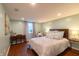 Bedroom featuring wood floors, a large bed, a desk, and natural light at 5609 Meadowood Dr, Indianapolis, IN 46224