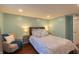 Bedroom featuring wood floors, neutral tones, and a cozy reading nook at 5609 Meadowood Dr, Indianapolis, IN 46224