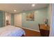 Bedroom featuring wood floors, an art piece, a desk, and a closet at 5609 Meadowood Dr, Indianapolis, IN 46224