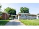 Inviting single-story home with brick and stone accents, a well-kept lawn, and a convenient carport at 5609 Meadowood Dr, Indianapolis, IN 46224