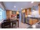 Well-equipped kitchen featuring stainless steel appliances, warm wood cabinetry, and modern fixtures at 5609 Meadowood Dr, Indianapolis, IN 46224