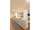 Open wet bar features granite countertops, sleek gray cabinets, and a view into the cozy living area at 5609 Meadowood Dr, Indianapolis, IN 46224