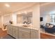 View of the wet bar area with granite countertops and cabinetry flowing into the living area at 5609 Meadowood Dr, Indianapolis, IN 46224