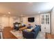 Spacious basement living room features cozy seating, built-in cabinets, and a modern TV at 5609 Meadowood Dr, Indianapolis, IN 46224