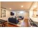 Comfortable living room with cozy seating, a piano, and view of the kitchenette area at 5609 Meadowood Dr, Indianapolis, IN 46224