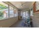 Cozy screened-in porch perfect for relaxing, with ample seating and natural light at 5609 Meadowood Dr, Indianapolis, IN 46224