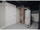 Basement features a modern hot water tank and updated utilities at 5636 Crittenden Ave, Indianapolis, IN 46220