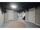 Basement with white walls, two doors, black ductwork, and a beige rug at 5636 Crittenden Ave, Indianapolis, IN 46220