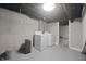 Basement laundry area with a bright painted floor and utility access, plus ample storage at 5636 Crittenden Ave, Indianapolis, IN 46220