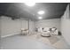 Basement with a stylish seating arrangement, modern lighting, and a cozy rug at 5636 Crittenden Ave, Indianapolis, IN 46220