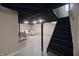 Basement with freshly painted walls and a finished seating area under a stairway at 5636 Crittenden Ave, Indianapolis, IN 46220