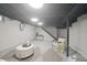 Open basement area with a seating area, modern decor, and a neutral-toned rug at 5636 Crittenden Ave, Indianapolis, IN 46220