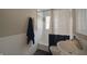Cozy bathroom features black and white decor, ceramic tile, pedestal sink, and shower at 5636 Crittenden Ave, Indianapolis, IN 46220