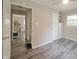 Bedroom featuring wood-look floors, neutral walls and a large storage closet at 5636 Crittenden Ave, Indianapolis, IN 46220