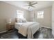 Cozy bedroom with a ceiling fan, wood-look floors, and warm neutral walls at 5636 Crittenden Ave, Indianapolis, IN 46220