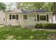 Charming home showcasing a quaint front yard and inviting facade with neat landscaping at 5636 Crittenden Ave, Indianapolis, IN 46220