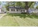 Inviting single-story home with a lush front lawn and mature trees enhancing curb appeal at 5636 Crittenden Ave, Indianapolis, IN 46220