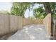Gravel area with new wooden fence, ideal for parking or outdoor projects at 5636 Crittenden Ave, Indianapolis, IN 46220